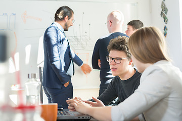 Image showing Relaxed informal IT business startup company team meeting.