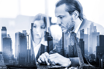 Image showing Business people in modern office against new york city manhattan buildings and skyscrapers window reflections.