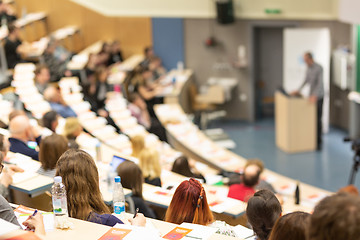 Image showing Expert speaker giving a talk at scientific business conference event.