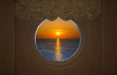 Image showing Beautiful Sunset Seen Through a round Ship Porthole