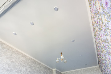 Image showing An outline of a stretch ceiling in a room with a chandelier and spotlights, with natural light