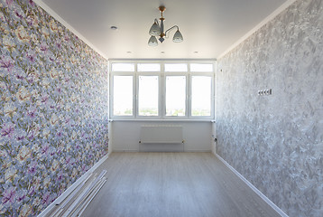 Image showing Empty room in the apartment after repair, with different wallpaper, with a large wide window