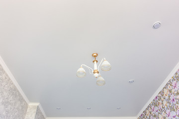 Image showing Stretch matte ceiling in the room with a chandelier and spotlights, with natural light