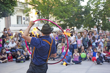 Image showing Street performer with a fire wheel 