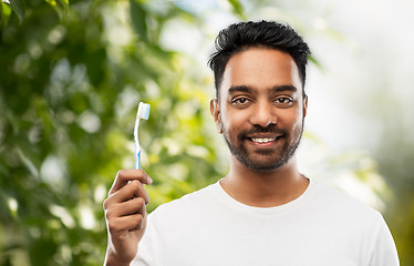 Image showing indian man with toothbrush over natural background