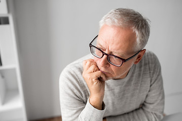 Image showing close up of senior man in glasses thinking