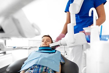 Image showing dentist making x-ray of kid teeth at dental clinic