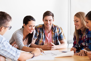 Image showing group of smiling students with blueprint