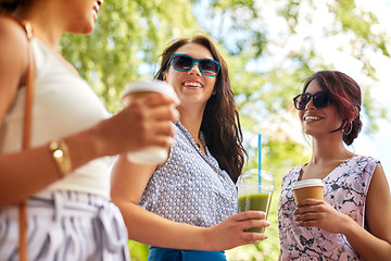 Image showing happy women or friends with drinks at summer park