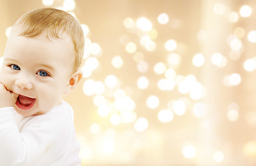 Image showing close up of sweet baby over christmas lights