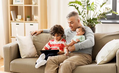 Image showing happy father with preteen and baby son at home