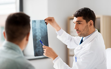 Image showing doctor showing x-ray to patient at hospital