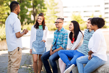 Image showing happy international friends talking in park