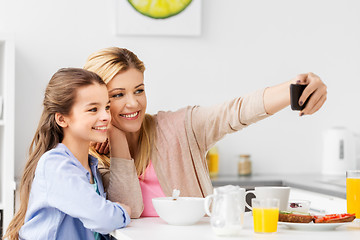 Image showing family taking selfie by smartphone at breakfast