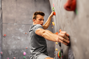 Image showing young man exercising at indoor climbing gym