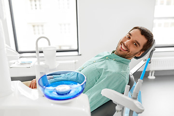 Image showing happy smiling male patient at dental clinic