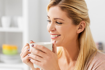 Image showing close up of happy woman with coffee cup at home