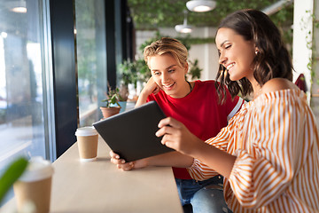 Image showing female friends with tablet pc and coffee at cafe