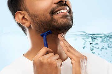 Image showing close up of man shaving beard with razor blade