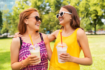 Image showing teenage girls with milk shakes at summer park