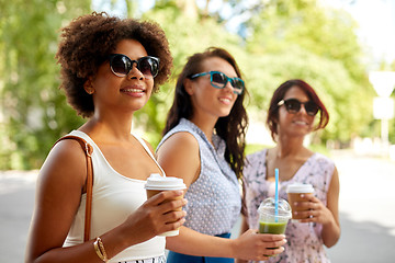 Image showing happy women or friends with drinks at summer park