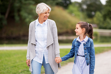 Image showing grandmother and granddaughter walking at park