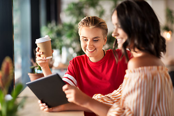 Image showing female friends with tablet pc and coffee at cafe