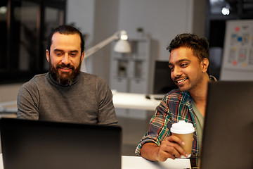 Image showing creative team drinking coffee at night office