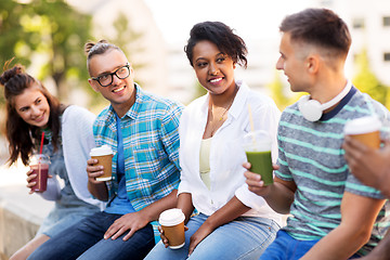 Image showing friends drinking coffee and juice talking in city