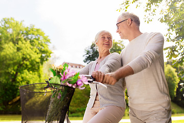 Image showing happy senior couple with bicycles at summer park