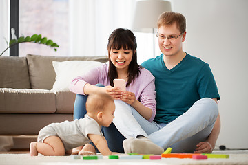 Image showing mixed race family with baby son playing at home