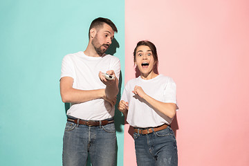 Image showing Closeup portrait of young couple, man, woman. One being excited 