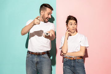 Image showing Closeup portrait of young couple, man, woman. One being excited 