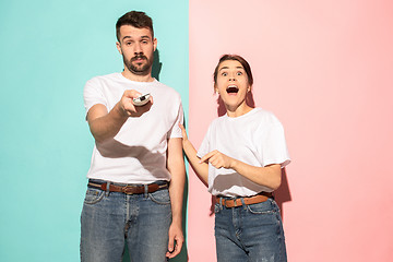 Image showing Closeup portrait of young couple, man, woman. One being excited 