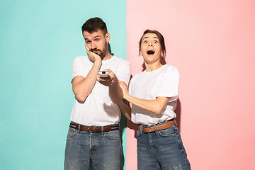 Image showing Closeup portrait of young couple, man, woman. One being excited 