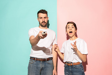 Image showing Closeup portrait of young couple, man, woman. One being excited 