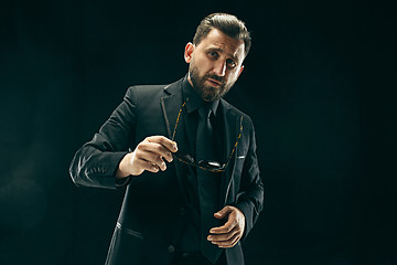 Image showing The barded man in a suit at black studio