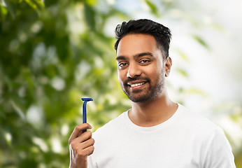 Image showing indian man with razor over natural background