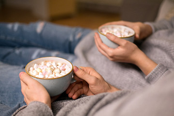 Image showing close up of couple drinking hot chocolate at home