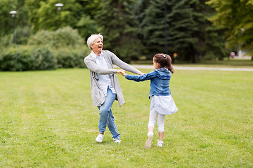 Image showing grandmother and granddaughter playing at park