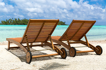 Image showing tropical beach with palm tree and sunbeds