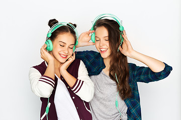 Image showing teenage girls in earphones listening to music