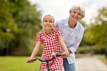 Image showing grandmother and granddaughter with bicycles