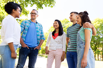 Image showing happy international friends talking in park