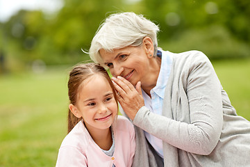 Image showing granddaughter sharing secrets with grandmother