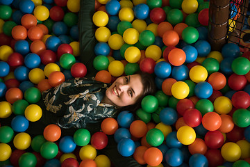 Image showing Young mom with her kids in a children\'s playroom