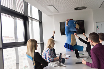 Image showing boss dresed as bear having fun with business people in trendy of