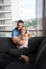 Image showing young handsome couple hugging on the sofa