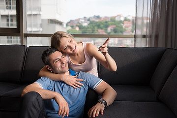 Image showing young handsome couple hugging on the sofa