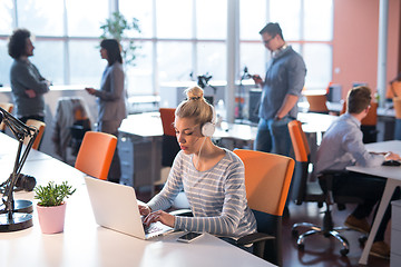 Image showing businesswoman using a laptop in startup office